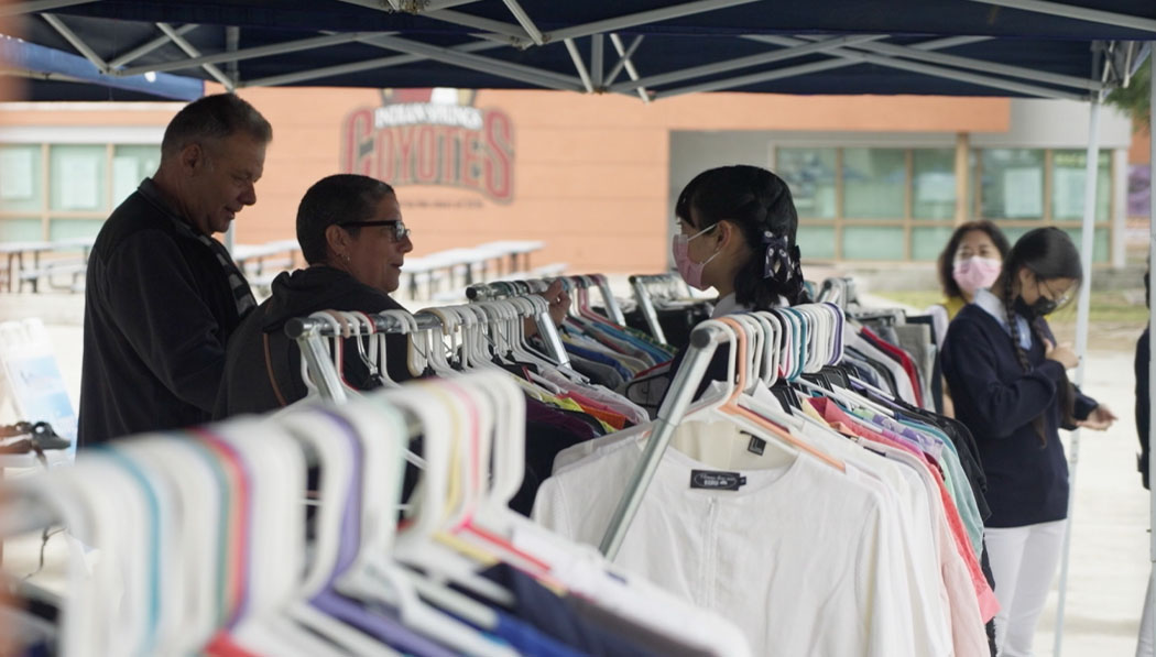 Tzu Chi volunteer and visitors in the second hand clothes booth