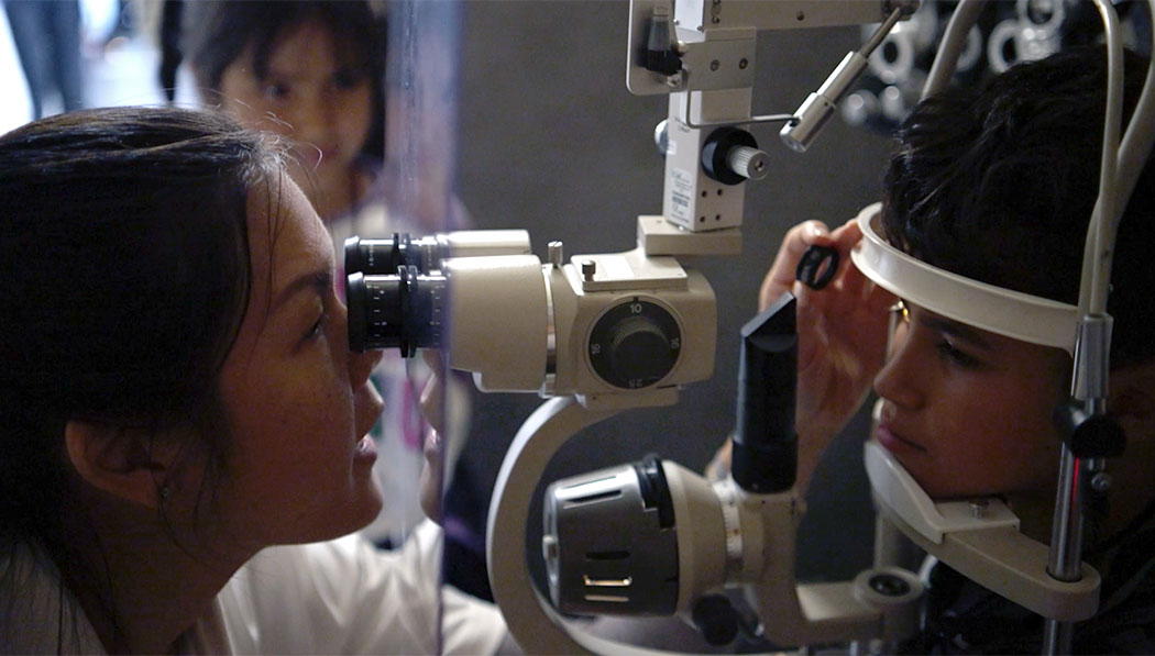 Tzu Chi medical volunteer giving eye exam