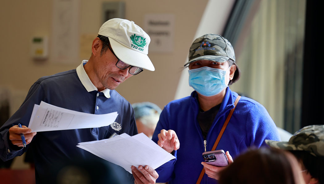 Tzu Chi volunteers in charge of reception assist the patients as they check-in.