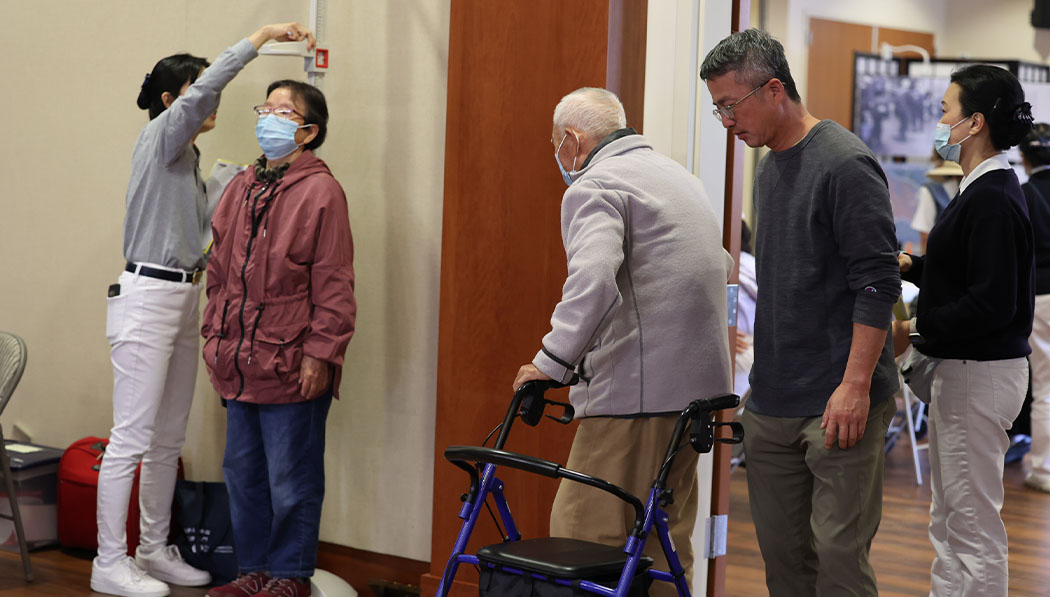 Tzu Chi volunteers guide patients through basic health checks height.