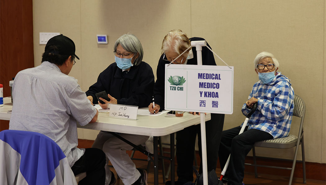 Western medicine practitioner Dr. Zhi Zhen Wang (left) brought his 99-year-old mother (right) to the clinic.