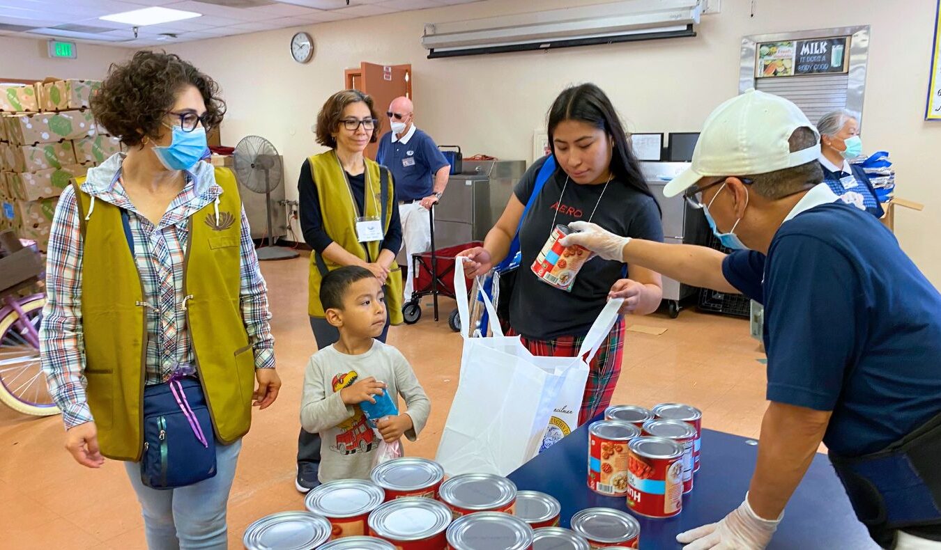 Visitors collecting foods from volunteers