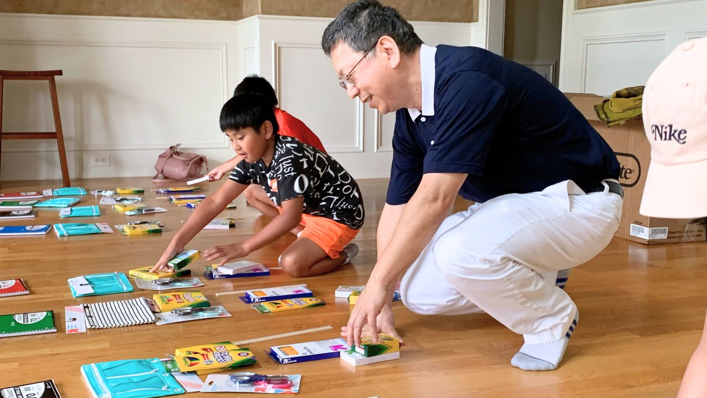 Tzu Chi volunteer Zhixing Chen takes the lead at the stationery drive.