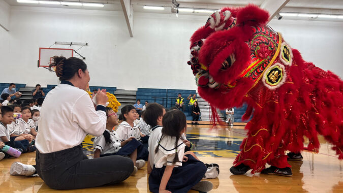 Students interacting with lion dance