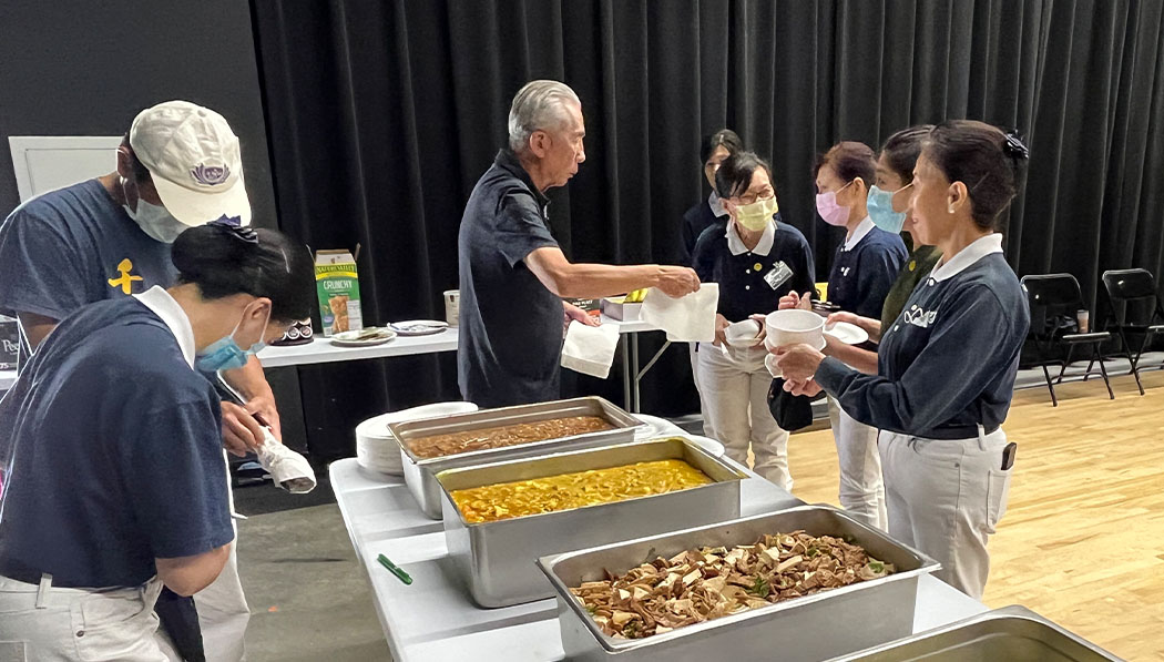 Tzu Chi USA culinary team volunteers offering food