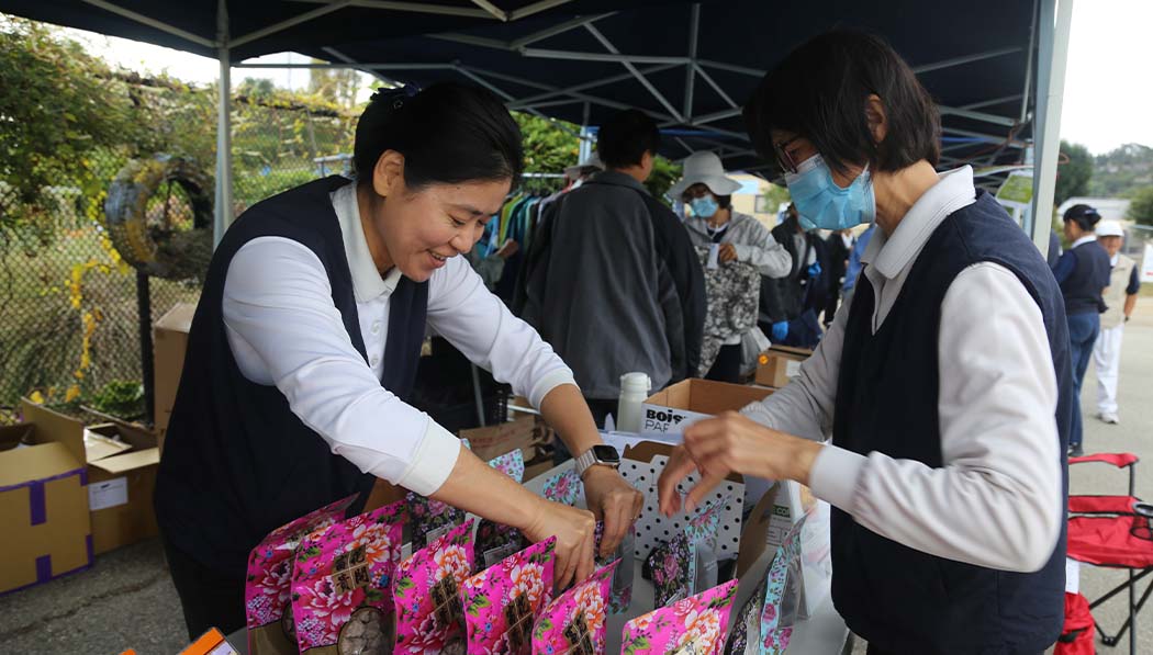 Tzu Chi volunteer organizing the selling items