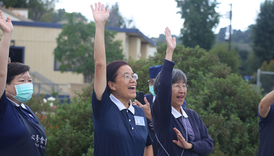 Tzu Chi volunteers raising their hands