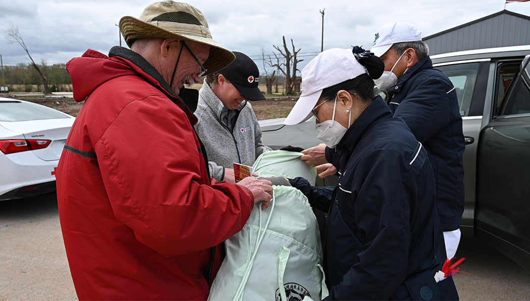 Care recipients receiving supply items from volunteer