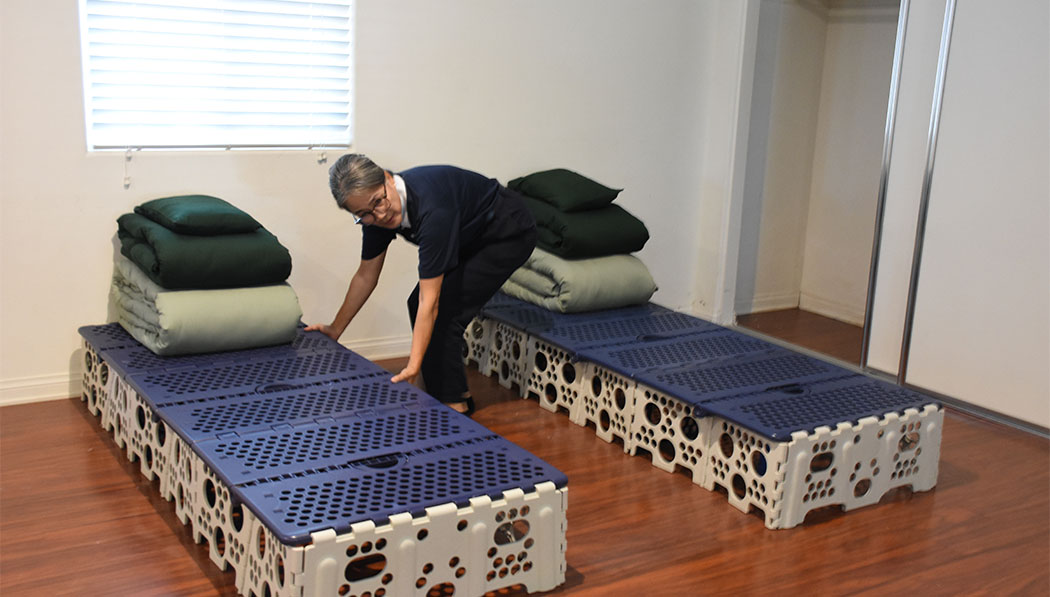 Volunteer setting up the beds for 3in1 retreat