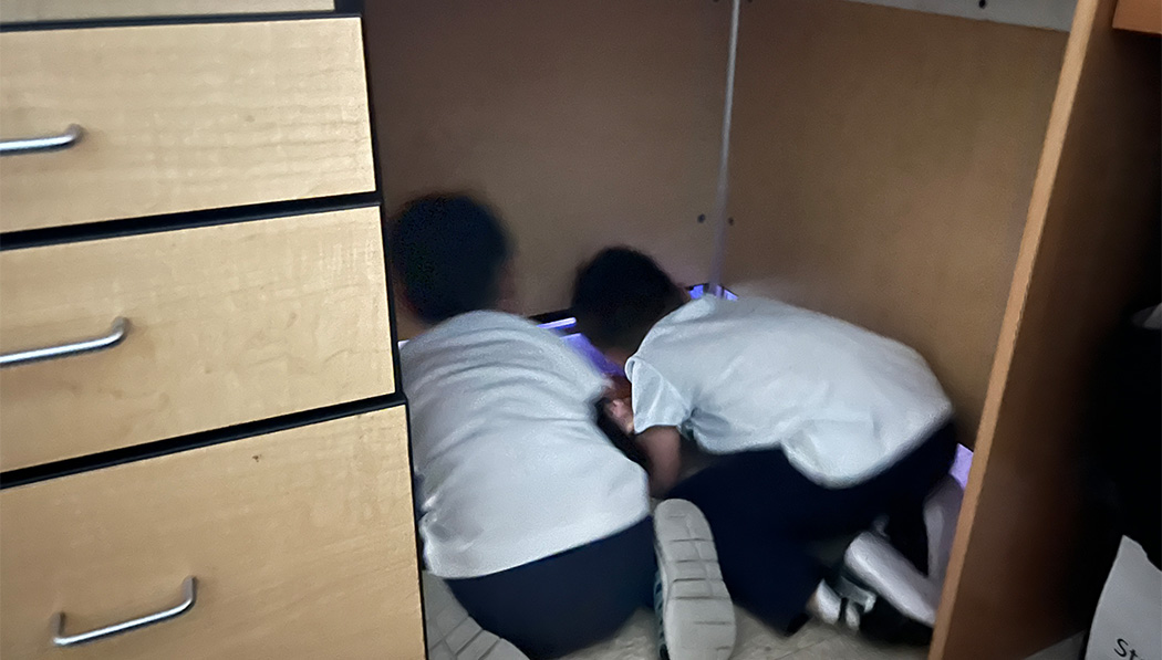 students hiding in the wardrobe