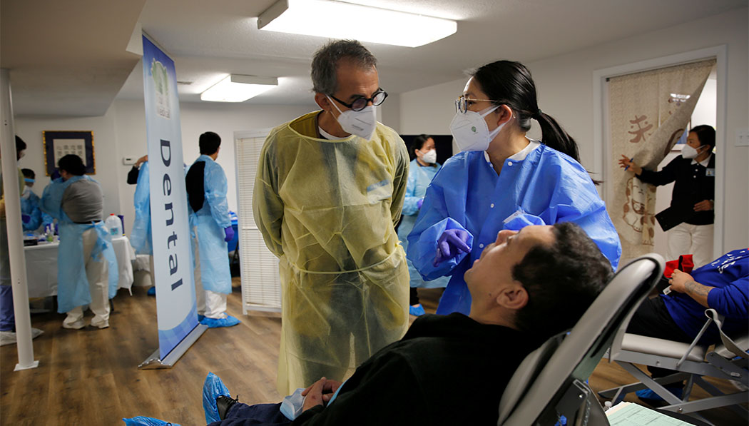 Dentist and assistant giving treatment to the patient