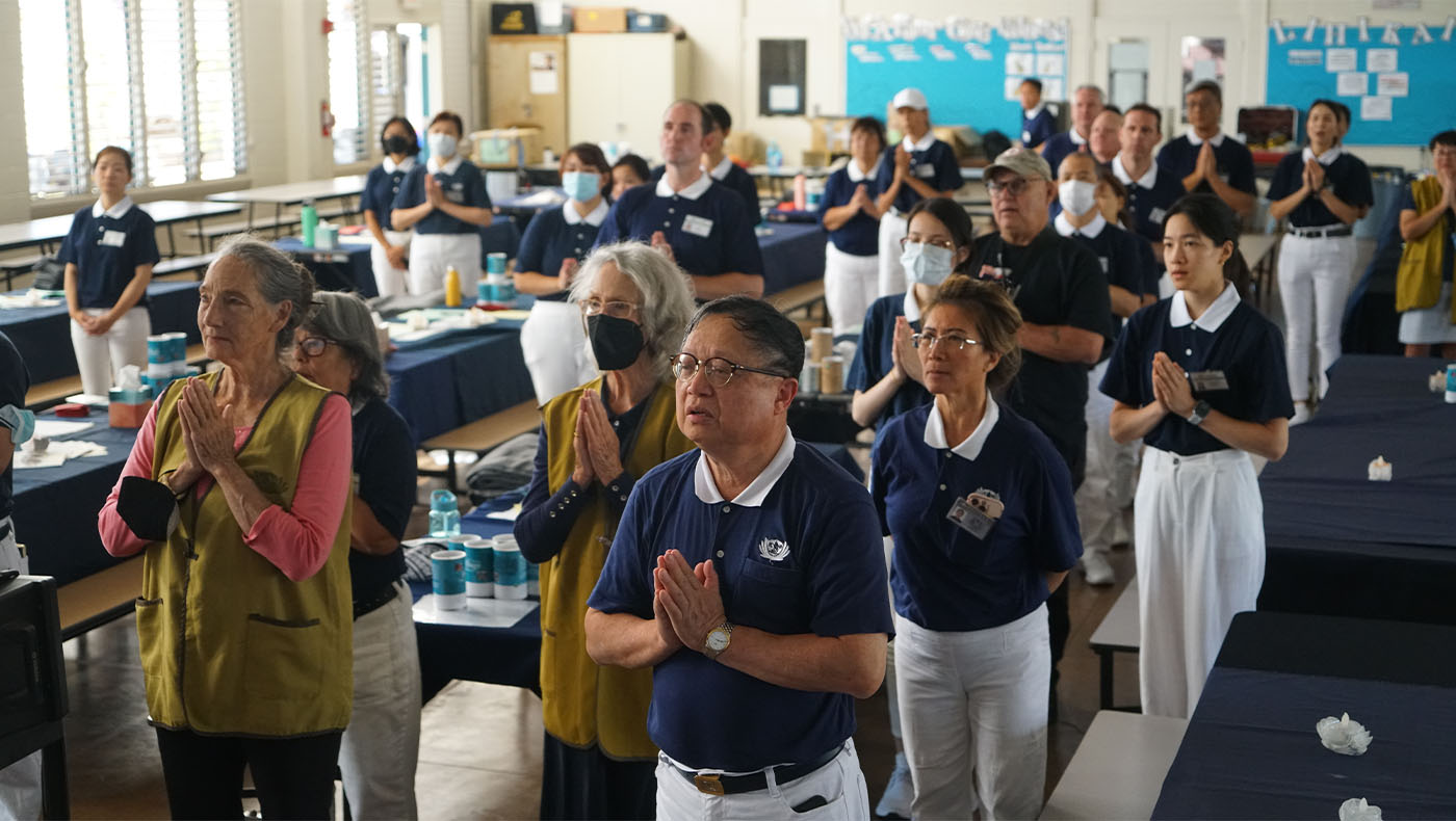 Volunteers praying for Maui