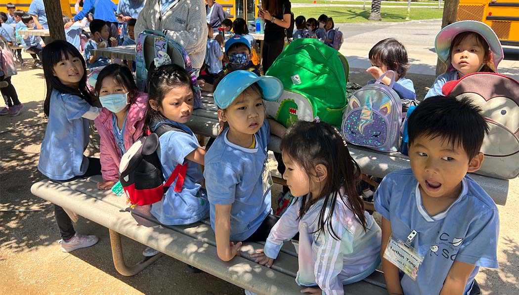 After arriving by school bus, the campers patiently wait to enter the Aquarium of the Pacific site. Photo/Michelle Young