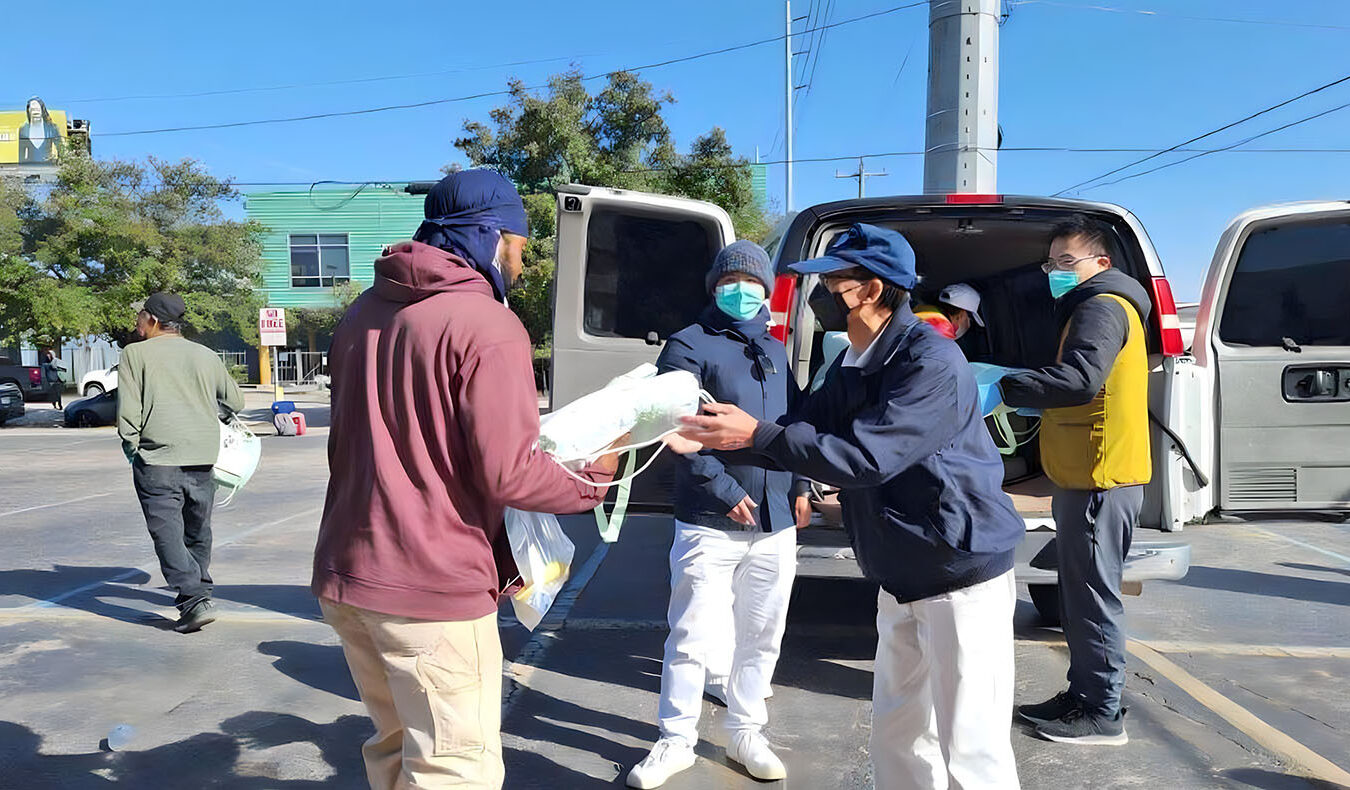 After opening their big cars, Tzu Chi volunteers began to distribute cold winter supplies to street residents.