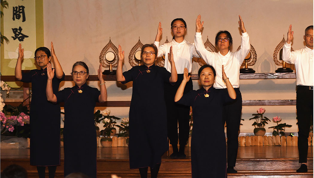 Tzu Chi volunteers performing sign language
