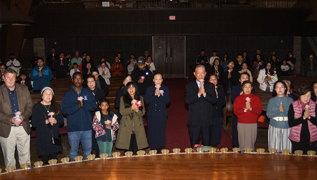 Yuanliang Ling, Central Region Executive Director, prays with the crowd