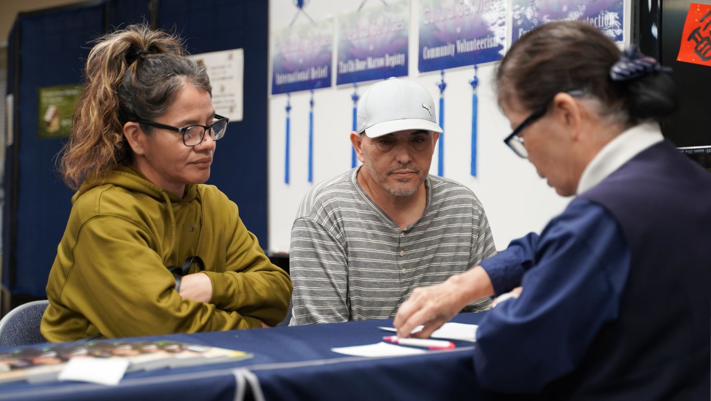 Lourdes (left) and Gabriel (middle) receive cash cards and supplies at the Tzu Chi San Diego Liaison Office.