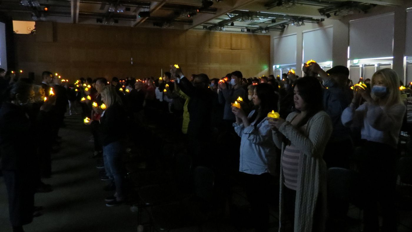 Congregation lighted candles and prayed for world peace.