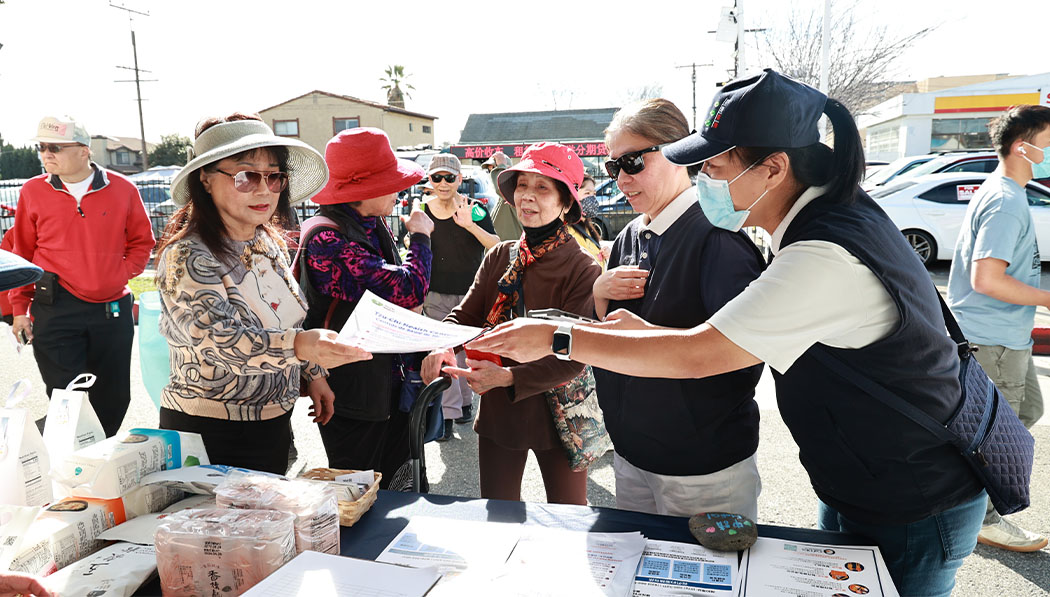 Tzu Chi volunteers distribute promotional materials to people interested in MediCal