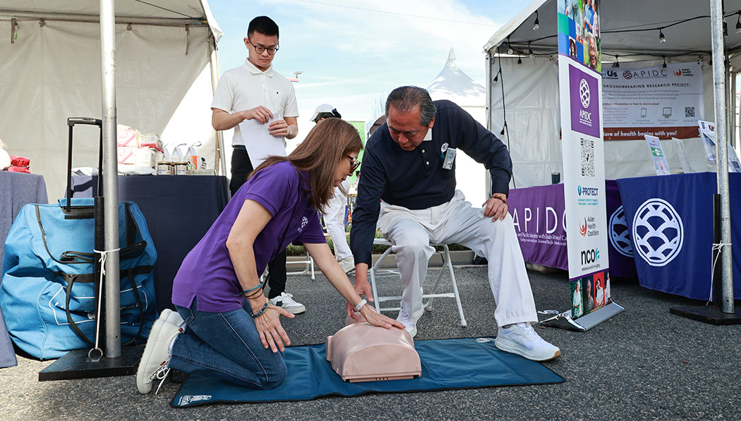 Volunteers guide people to learn CPR skills on site