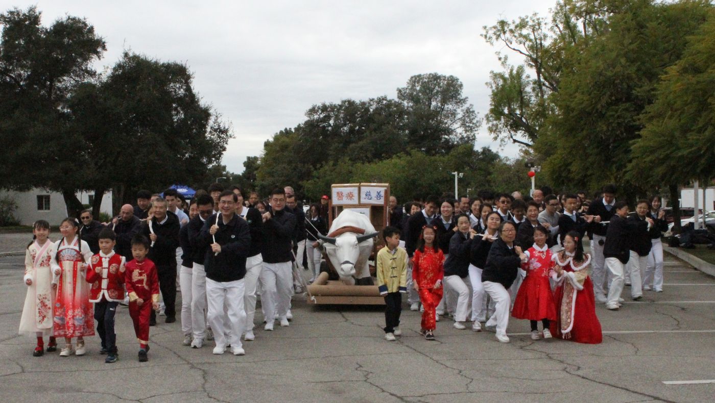 Tzu Chi USA volunteers of all ages pulled a white ox cart together to shoot a video celebrating the Year of the Dragon.