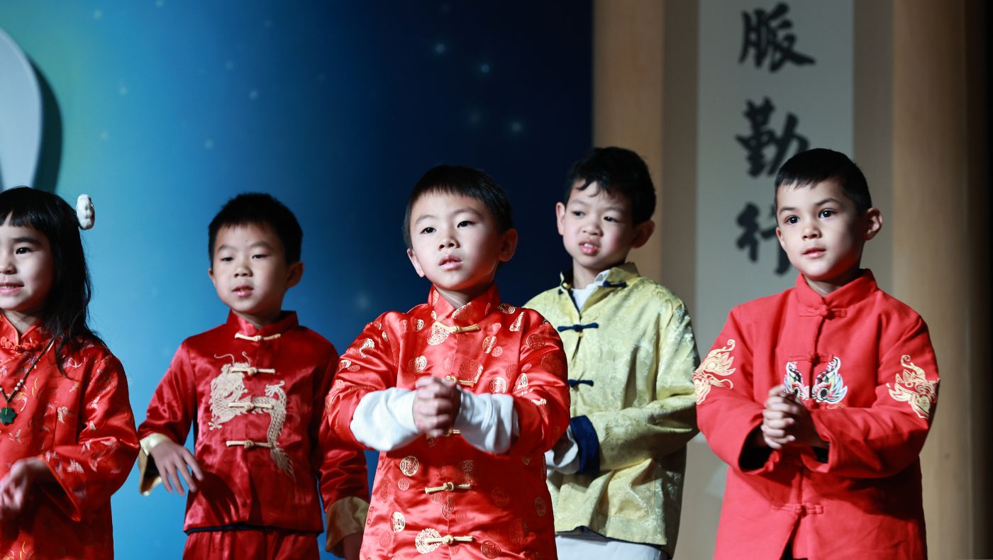 The children performed seriously on the stage.
