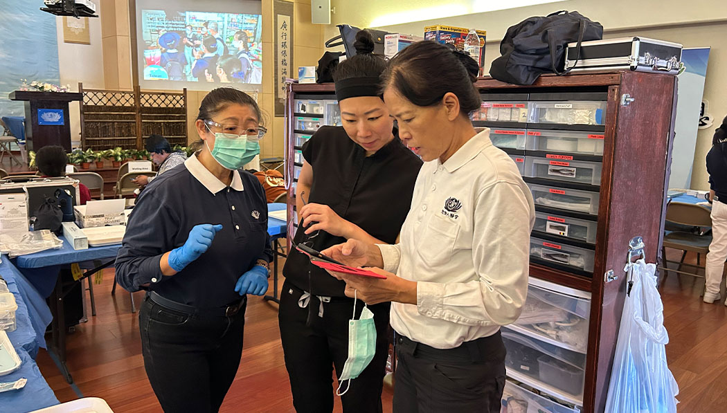 Dental implant surgeon Alice Hsieh interacting with volunteers