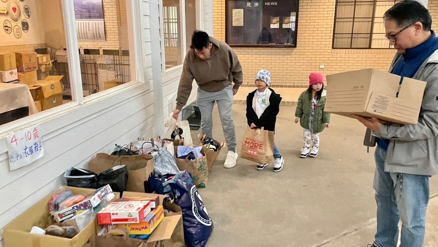 Parents assist their children in collecting second-hand charity supplies.