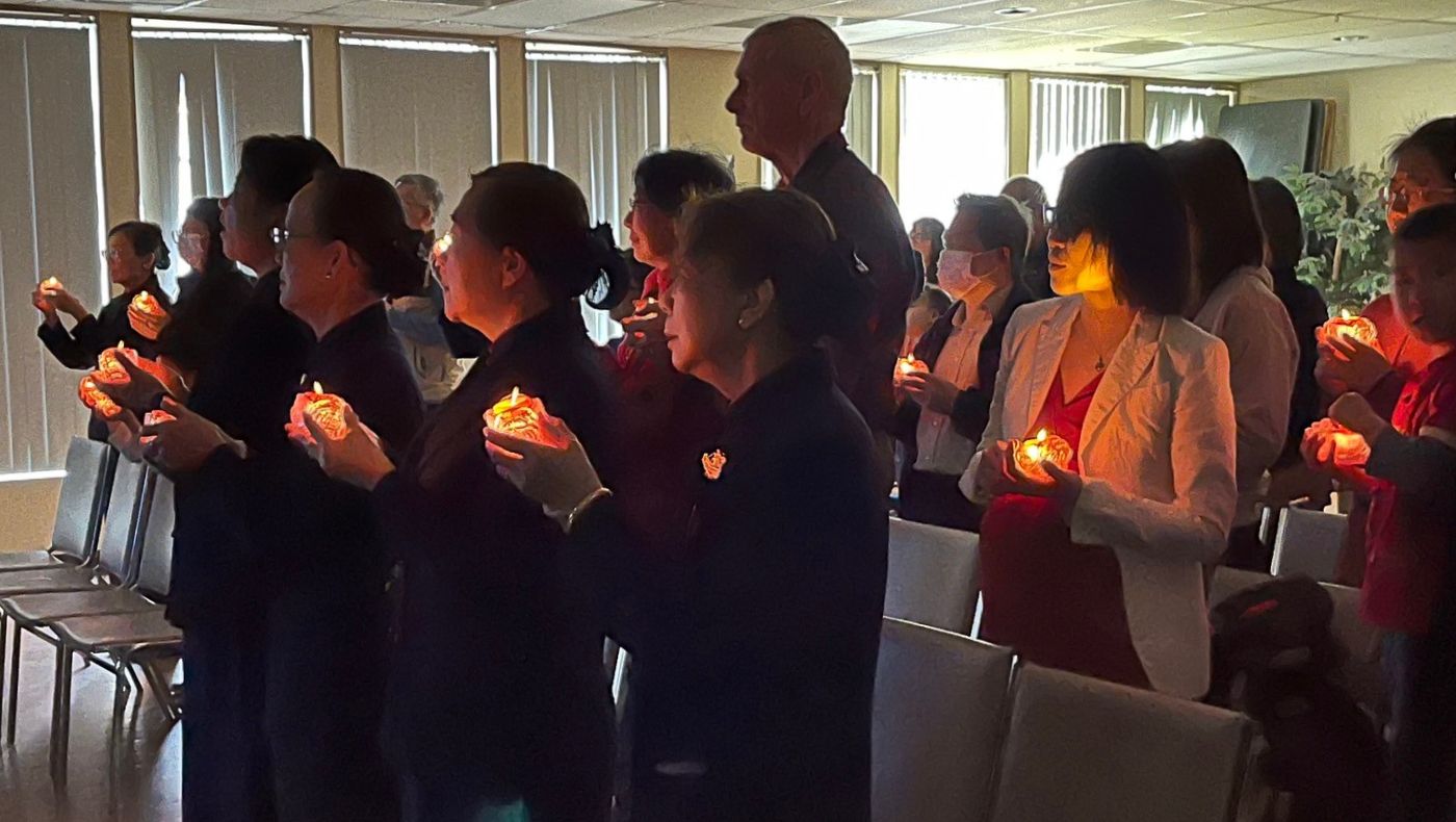 All the guests stood up, took out and lit the blessing and wisdom lanterns from under their chairs, clasped their hands together, and sang the prayers in their hearts.