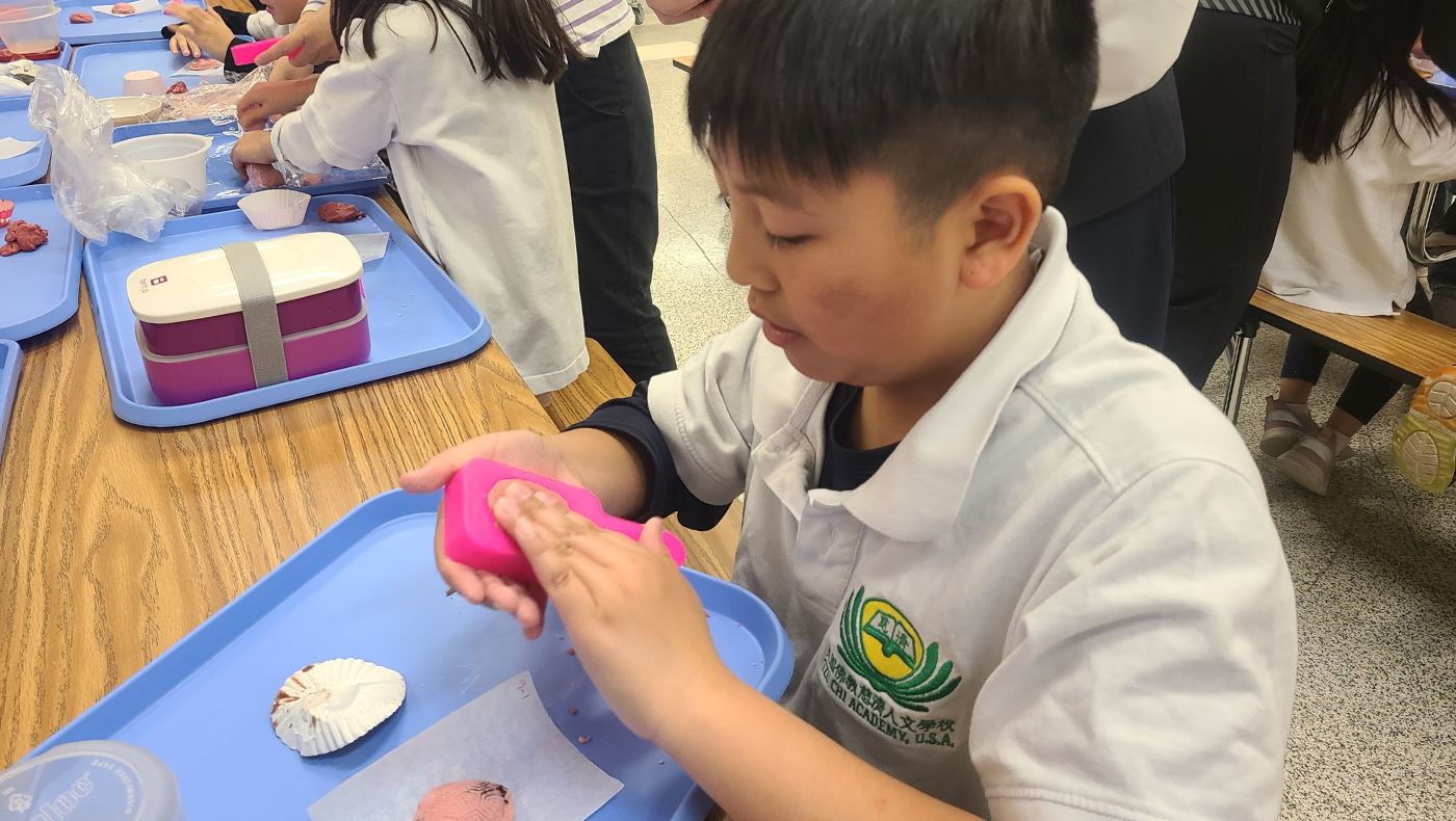 Students use molds to make cute red turtle cakes.