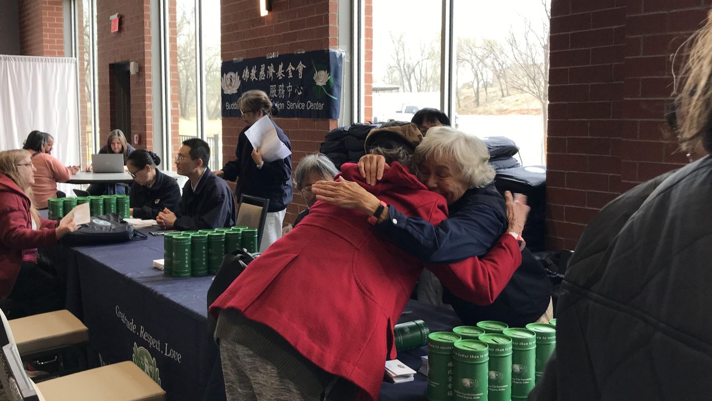 Tzu Chi volunteers warmly embrace the victims.