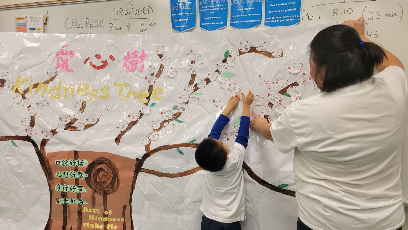 Los niños cuelgan sus buenas acciones en las ramas. Foto/Huiqing Su