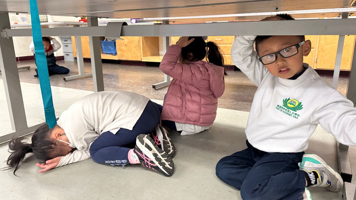 The students skillfully hid under their desks and conducted earthquake safety drills.