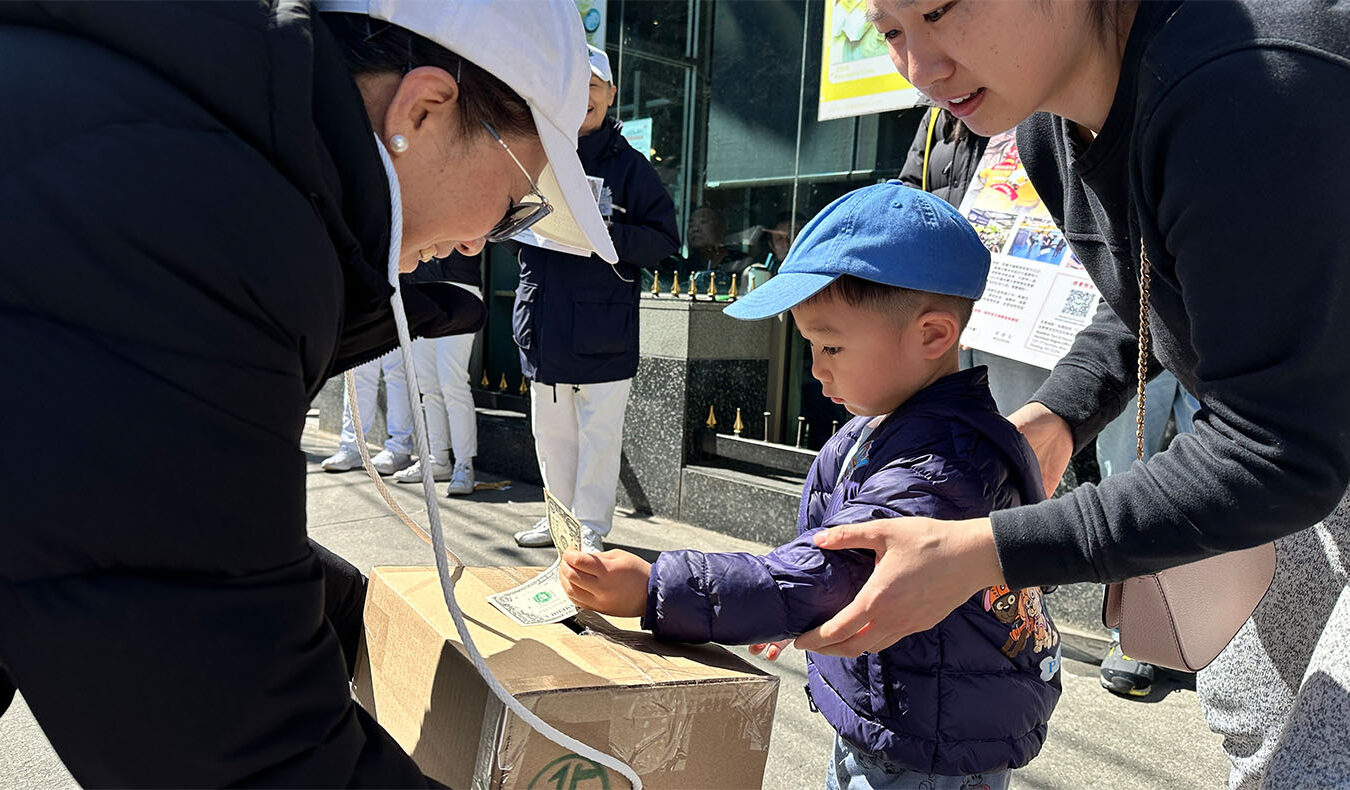 On the streets of Flushing, New York, a young boy donates money to earthquake victims.