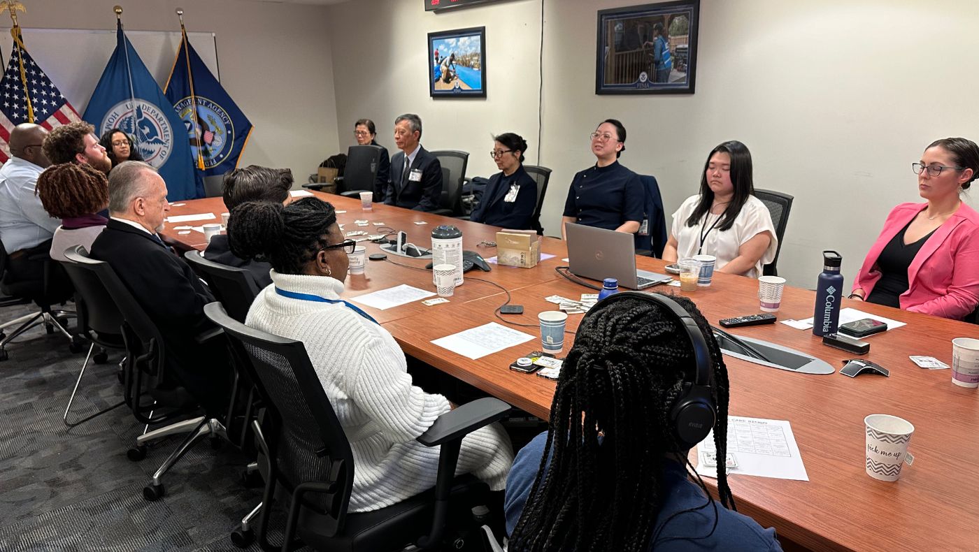 Tzu Chi volunteers lead FEMA employees to close their eyes and meditate to relieve stress.