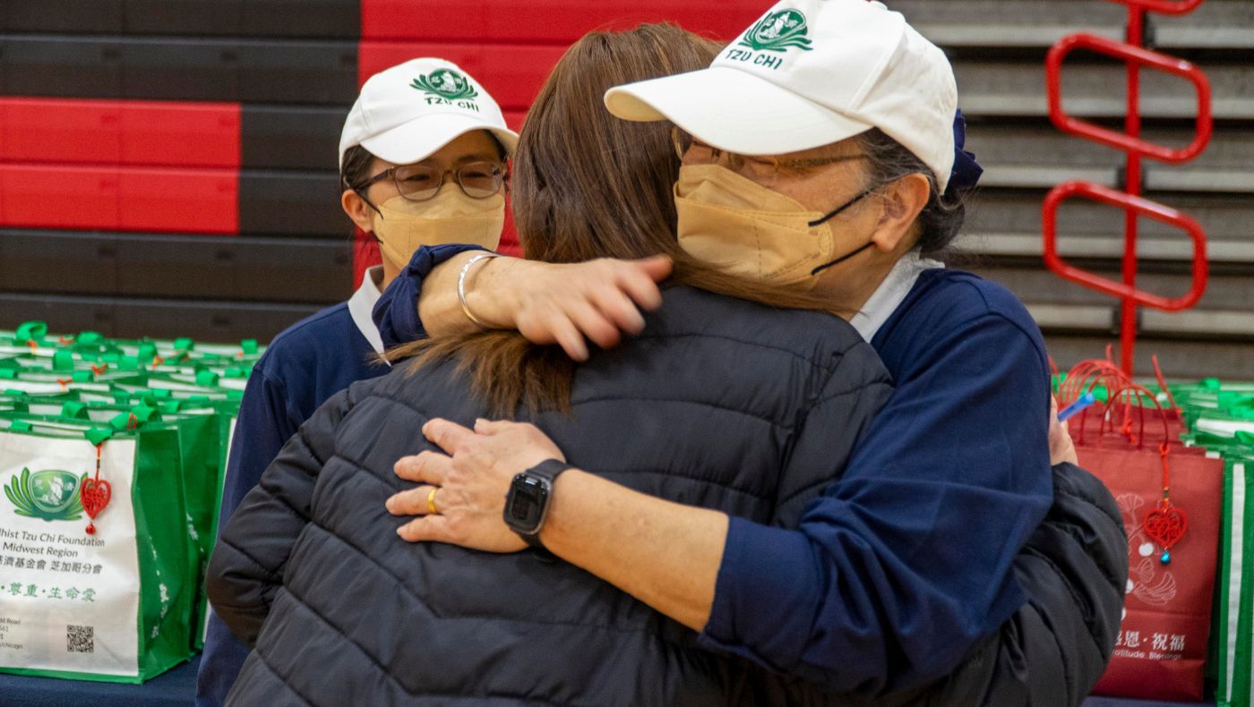Tzu Chi volunteers encourage victims with warm embraces.