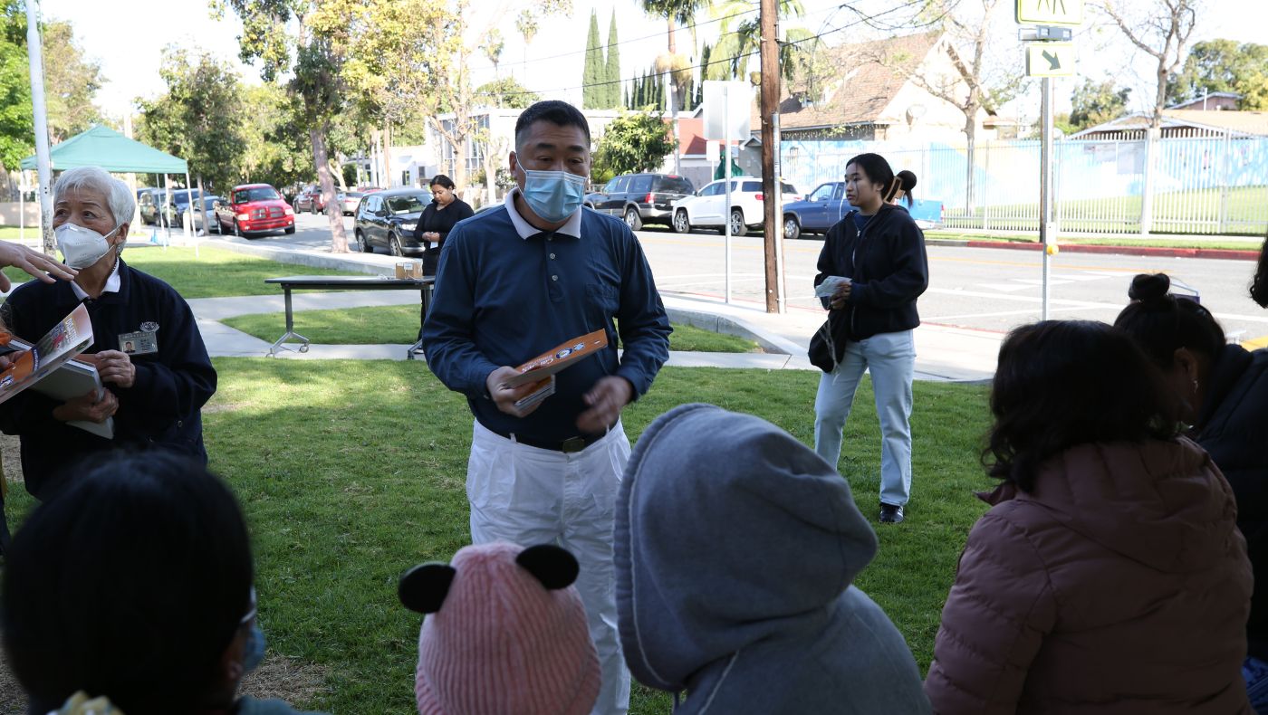 Tzu Chi volunteers distribute disaster prevention leaflets to patients in the community.