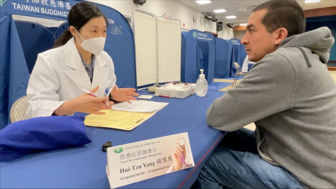 Chinese medicine practitioner Yang Huici (left) consults Allen (right).