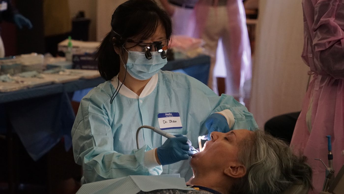 Dr. Zhao is seeing a patient's teeth.
