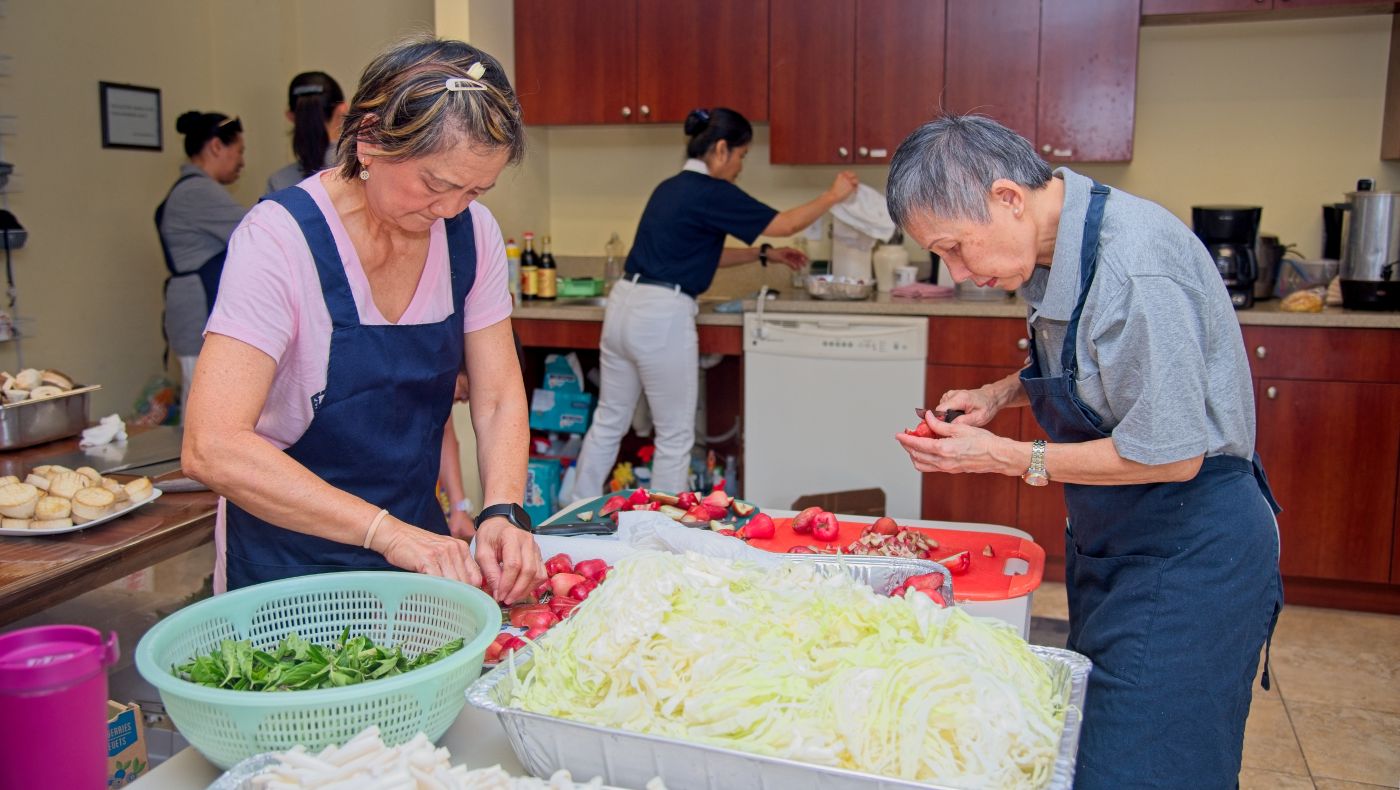 volunteers prepare lunch for the congregation in the kitchen.