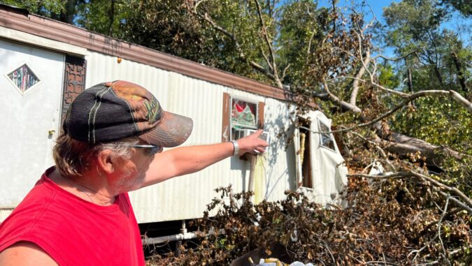 Mr. Bowman pointed out the location of the damage to the home to the volunteers.