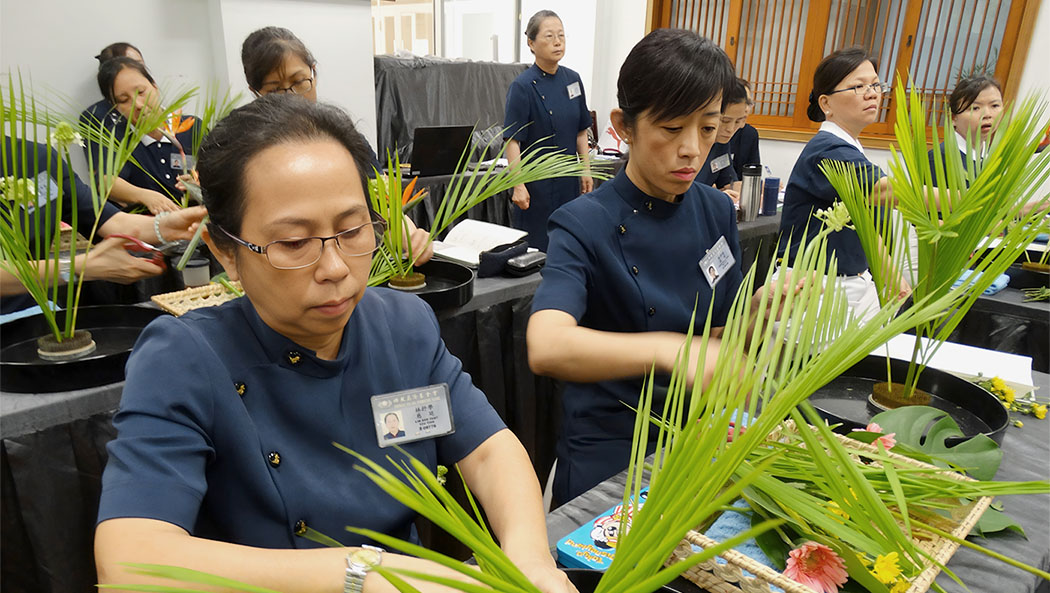 2014年6月21日，施靜娟（左二）於台灣新北市參加海外靜思花道專班，用心學習插花技巧，期許將所學帶回美國推動靜思花道。攝影／吳萬智