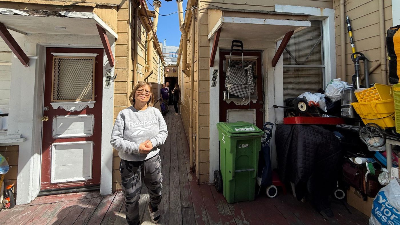The narrow alleyway is home to several families. In the photo is disaster survivor Susana Signio. Photo/Lulu Yin