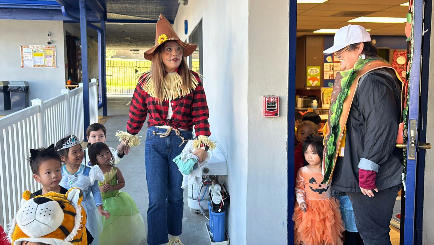 Teachers led children dressed in Halloween costumes in a parade on campus. Photo by Wu Jin