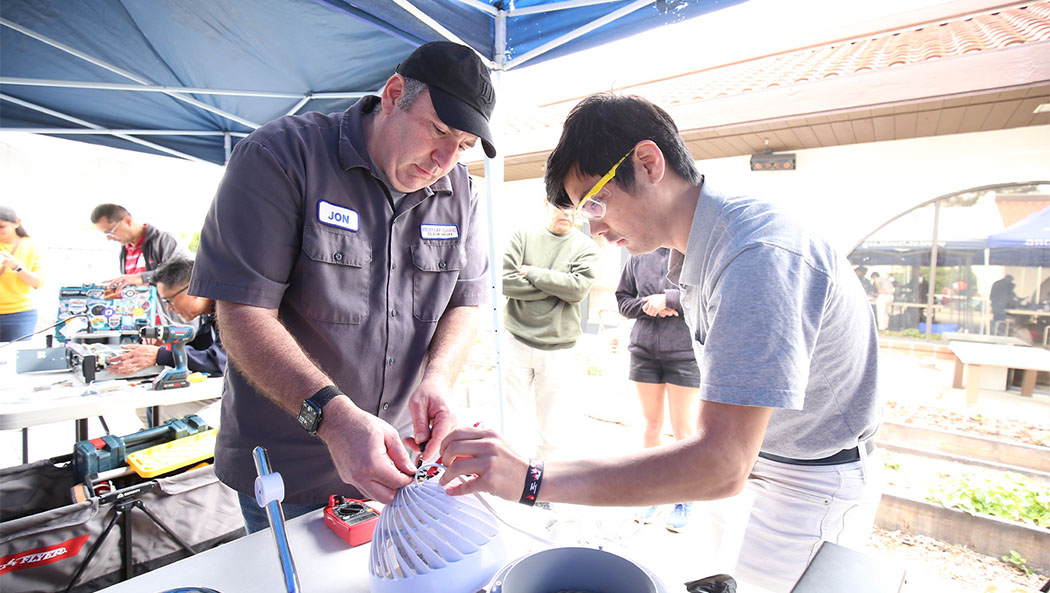The outdoor repair area is set up under a tent in the courtyard. Photo/Pohan Chen