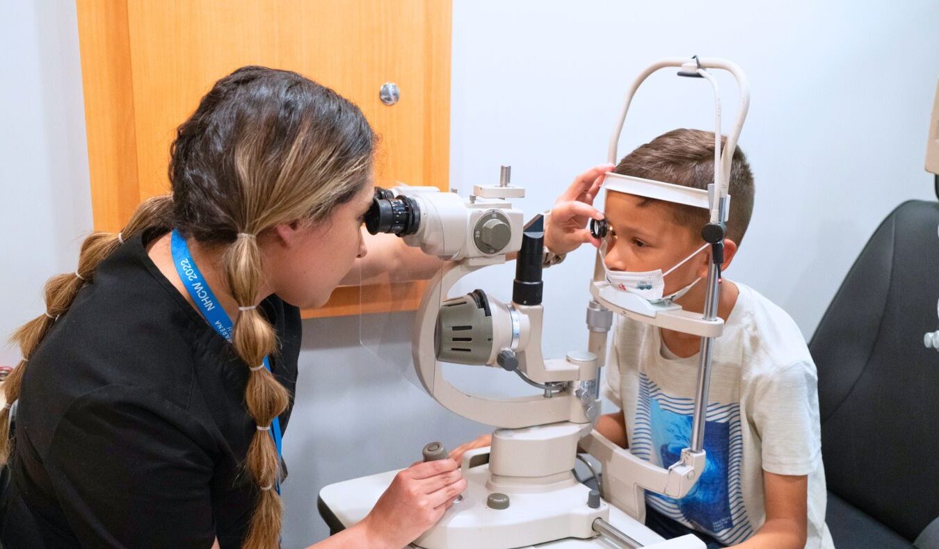 Tzu Chi medical volunteers check a child’s eyesight.
