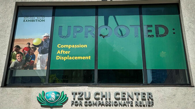 Facade of Tzu Chi Center and the poster of Uprooted: Compassion After Displacement Compassionate Exhibition