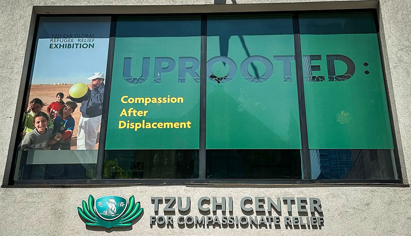 Facade of Tzu Chi Center and the poster of Uprooted: Compassion After Displacement Compassionate Exhibition