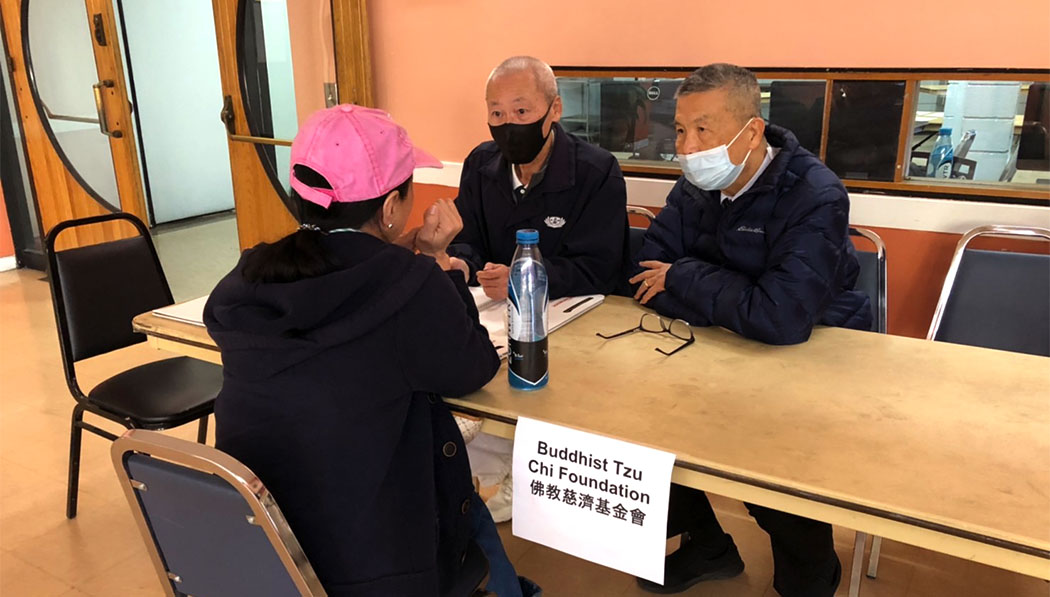 Tzu Chi volunteers listening to the help seeker