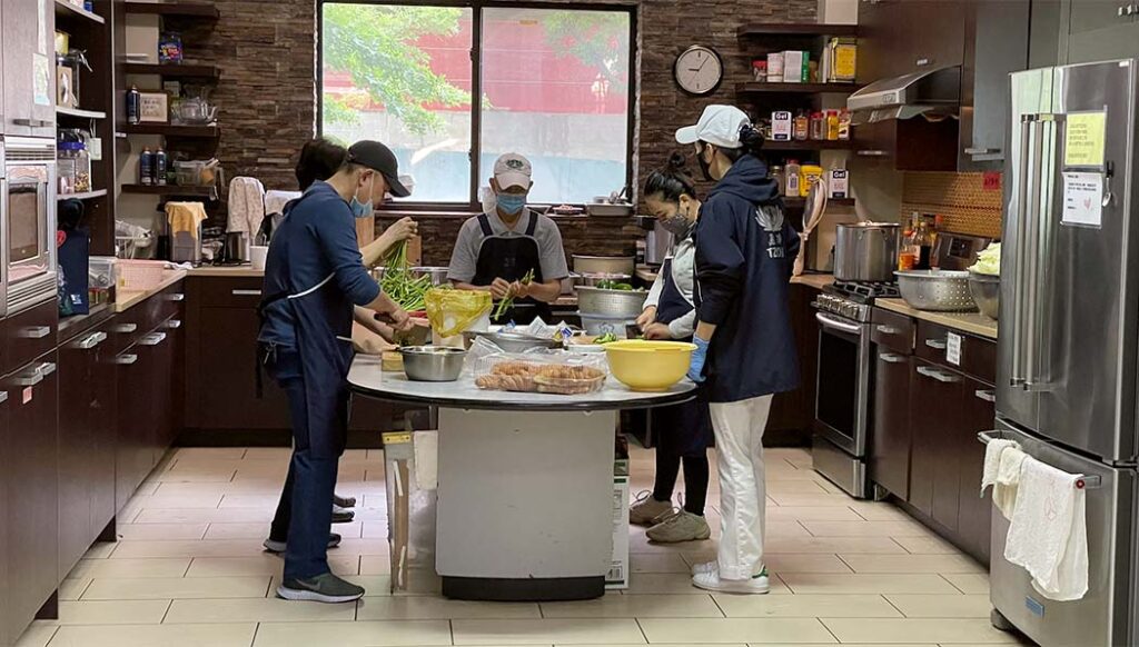 Tzu Chi volunteers preparing meals in Northeast Region's kitchen